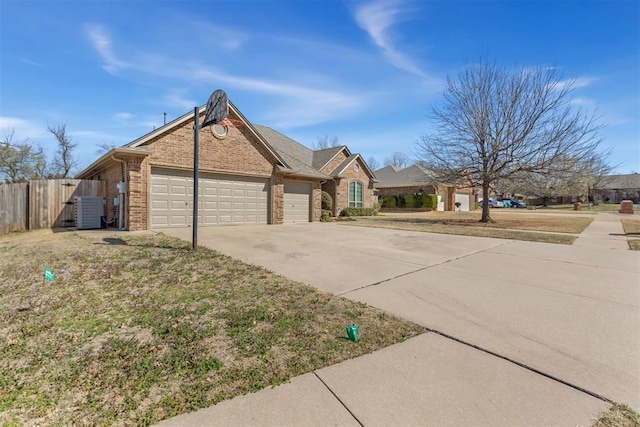 view of front of house with fence, driveway, a garage, central air condition unit, and brick siding