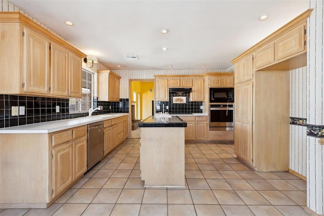 kitchen with light brown cabinets, a center island, wallpapered walls, light tile patterned floors, and stainless steel appliances