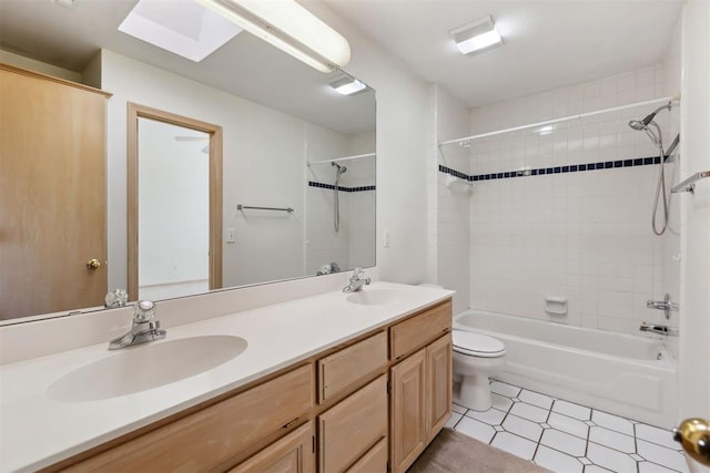 full bathroom featuring double vanity, toilet, shower / bathing tub combination, and a sink