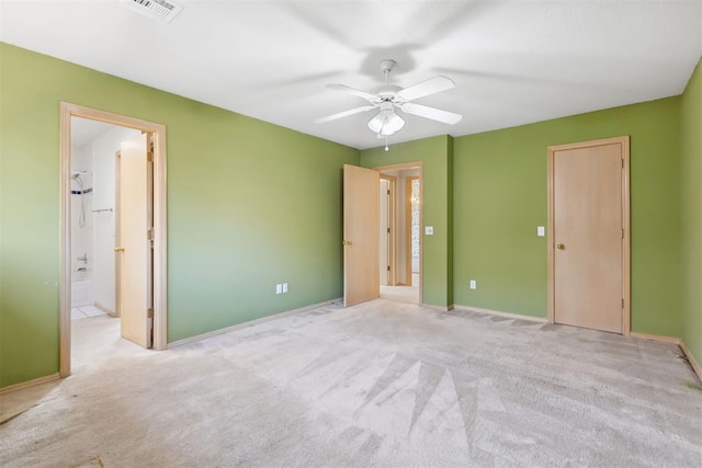 unfurnished bedroom featuring visible vents, ensuite bathroom, baseboards, and carpet flooring