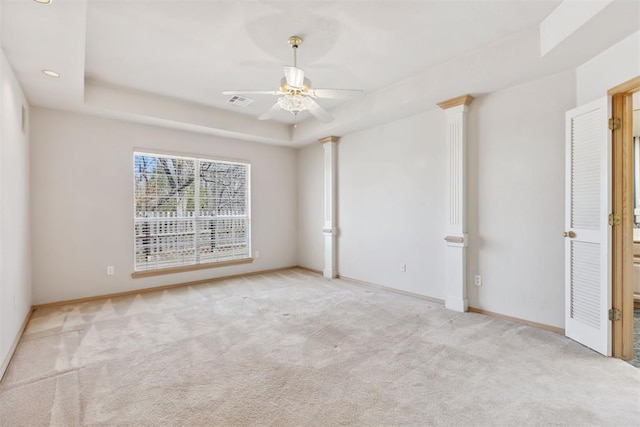 spare room featuring ceiling fan, baseboards, a tray ceiling, and carpet floors