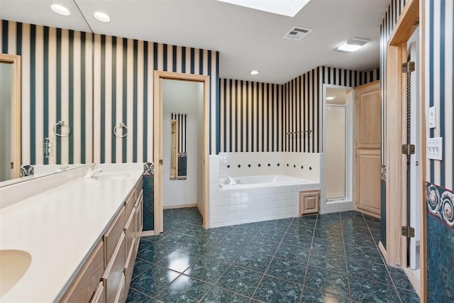 bathroom featuring visible vents, wallpapered walls, a garden tub, a stall shower, and vanity