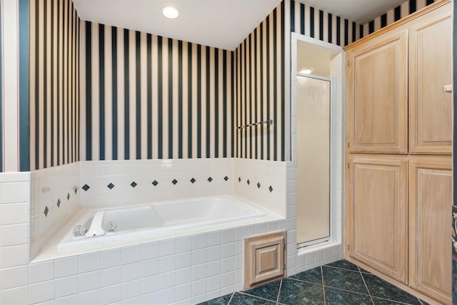 full bathroom featuring wallpapered walls, a shower stall, a bath, and tile patterned floors