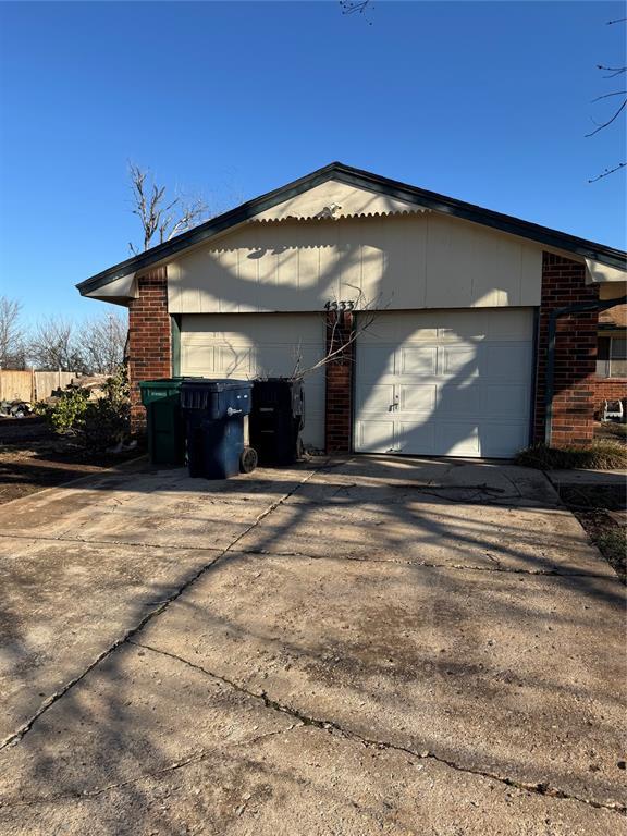 view of home's exterior featuring a garage and brick siding