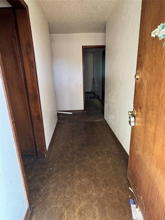 hallway with a textured ceiling