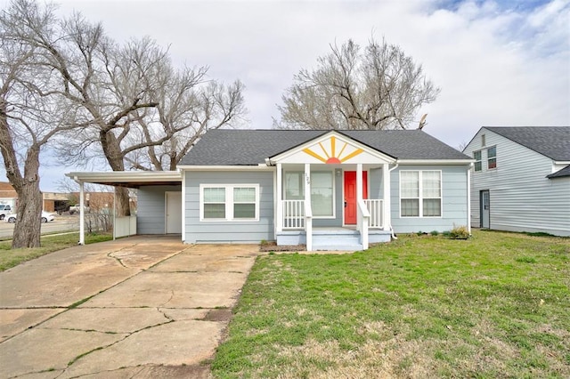 view of front of house with an attached carport, a front yard, covered porch, and driveway