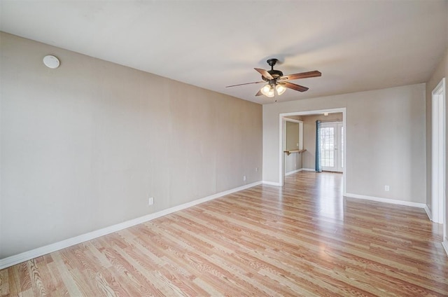 unfurnished room with light wood-style flooring, baseboards, and ceiling fan