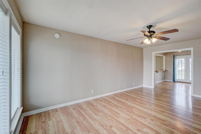 unfurnished room with wood finished floors, baseboards, french doors, and ceiling fan