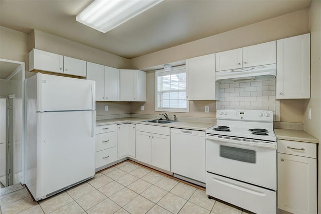 kitchen with white appliances, a sink, light countertops, under cabinet range hood, and white cabinetry