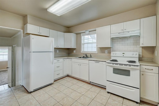 kitchen with white appliances, decorative backsplash, light countertops, under cabinet range hood, and white cabinetry