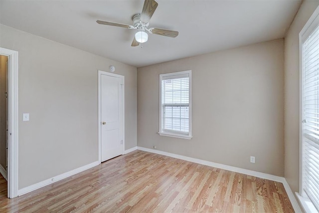 unfurnished bedroom featuring light wood-type flooring, baseboards, and ceiling fan