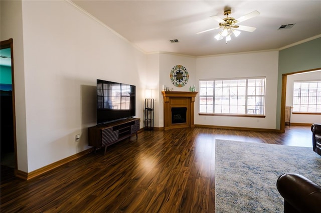 unfurnished living room with visible vents, ornamental molding, a fireplace, and wood finished floors