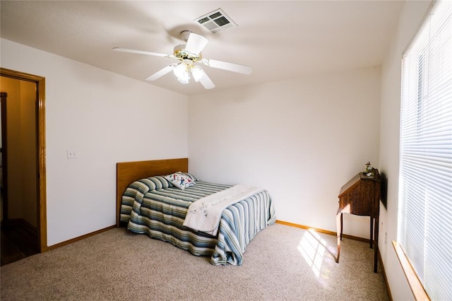 carpeted bedroom featuring visible vents, ceiling fan, and baseboards