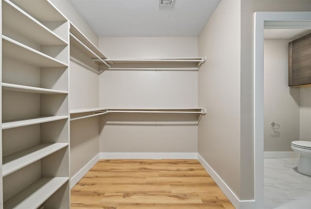 spacious closet featuring visible vents and marble finish floor