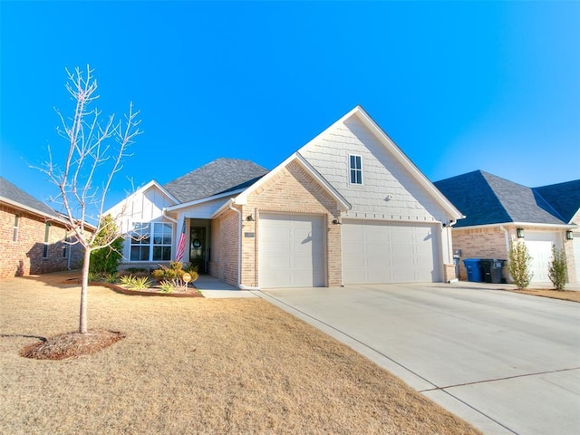 view of front of home with concrete driveway, an attached garage, and brick siding