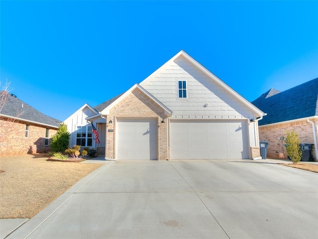 view of front of house featuring brick siding and concrete driveway