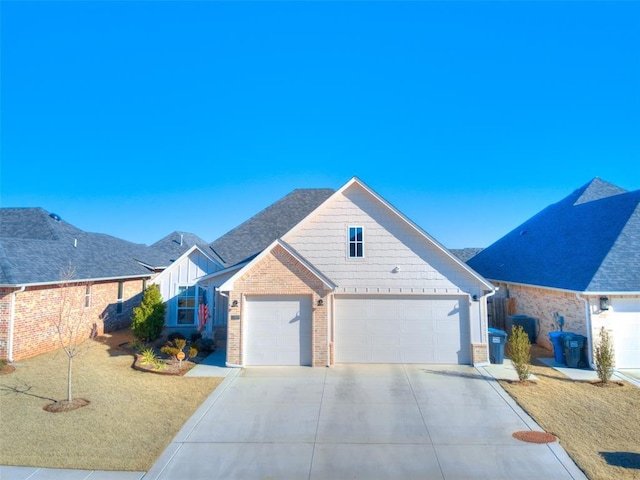 view of front of house featuring a front lawn, brick siding, roof with shingles, and driveway