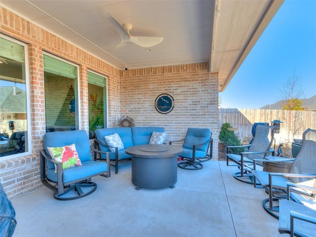 view of patio featuring an outdoor living space and fence