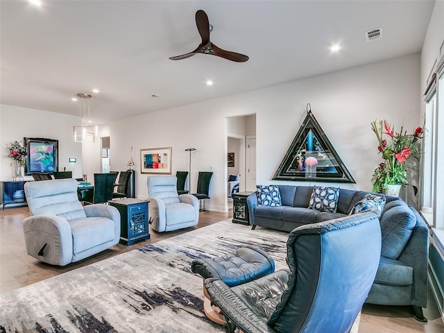 living area featuring recessed lighting, visible vents, light wood-style flooring, and a ceiling fan