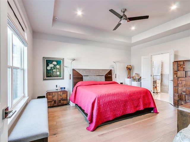 bedroom with recessed lighting, ceiling fan, a tray ceiling, and wood finished floors