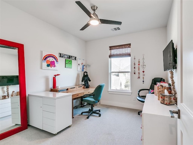 home office with visible vents, light colored carpet, and a ceiling fan