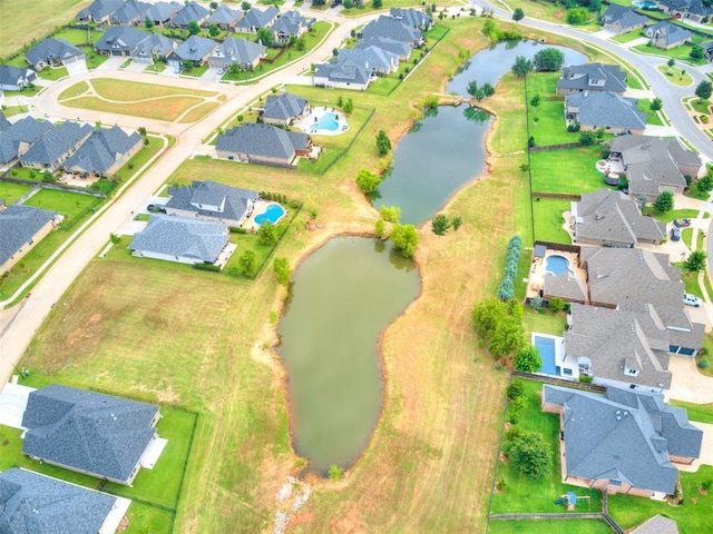 birds eye view of property with a residential view and a water view