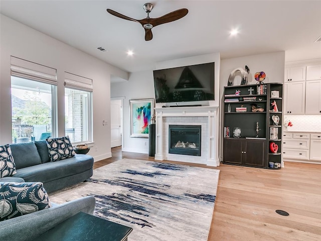 209 Pont Neuf Ct, Edmond, OK 73034 - living area with a ceiling fan, a fireplace, light wood-style flooring, and recessed lighting