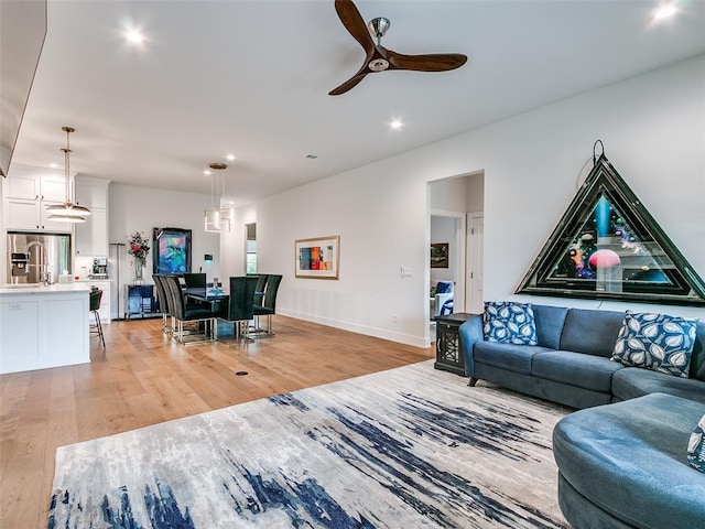 209 Pont Neuf Ct, Edmond, OK 73034 - living room featuring light wood finished floors, recessed lighting, a ceiling fan, and baseboards