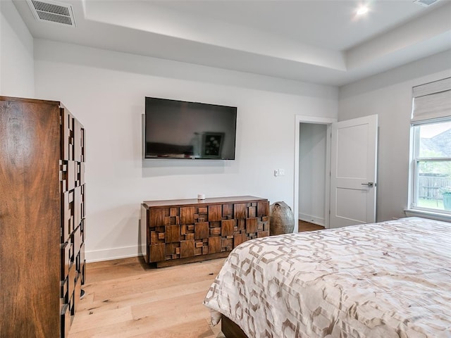 209 Pont Neuf Ct, Edmond, OK 73034 - bedroom with wood finished floors, a raised ceiling, and baseboards