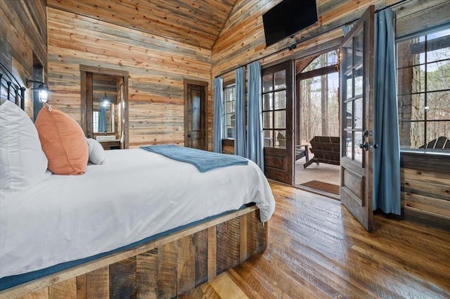 bedroom featuring wooden walls, french doors, wood finished floors, high vaulted ceiling, and access to outside