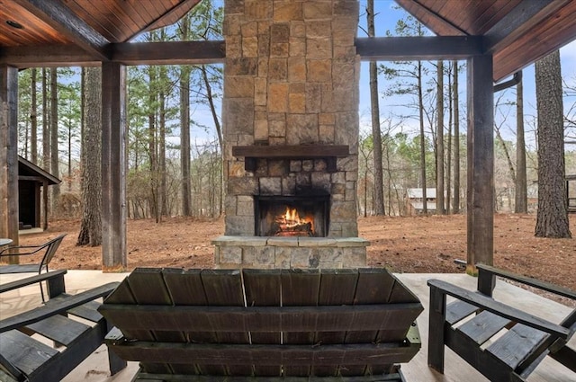 view of yard featuring an outdoor stone fireplace