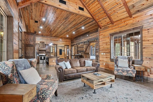 living room featuring wooden ceiling, wooden walls, a barn door, and concrete floors