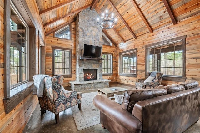 living room featuring wooden walls, beam ceiling, a fireplace, wooden ceiling, and a chandelier