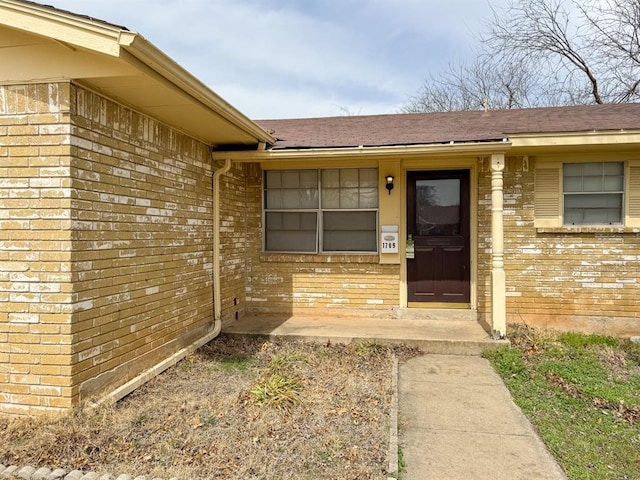 entrance to property with brick siding