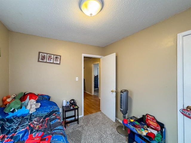 carpeted bedroom with a textured ceiling