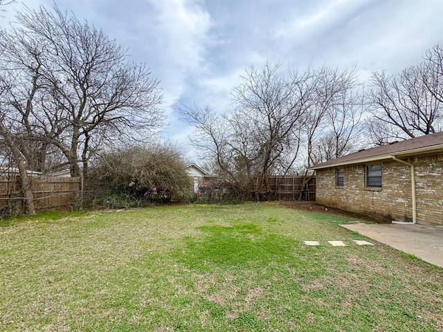 view of yard featuring a patio and fence