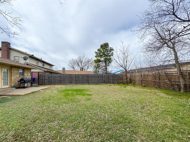 view of yard featuring a patio area and a fenced backyard