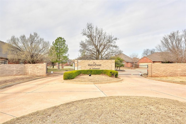 exterior space featuring a gate, curbs, and a gated entry