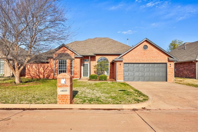 ranch-style house with a front yard, a shingled roof, concrete driveway, a garage, and brick siding