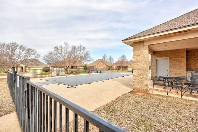 view of pool featuring fence and a patio area