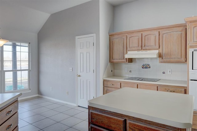 kitchen featuring under cabinet range hood, black electric cooktop, light brown cabinets, and light countertops