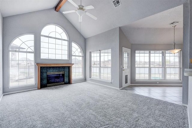 unfurnished living room with beam ceiling, visible vents, ceiling fan, and carpet