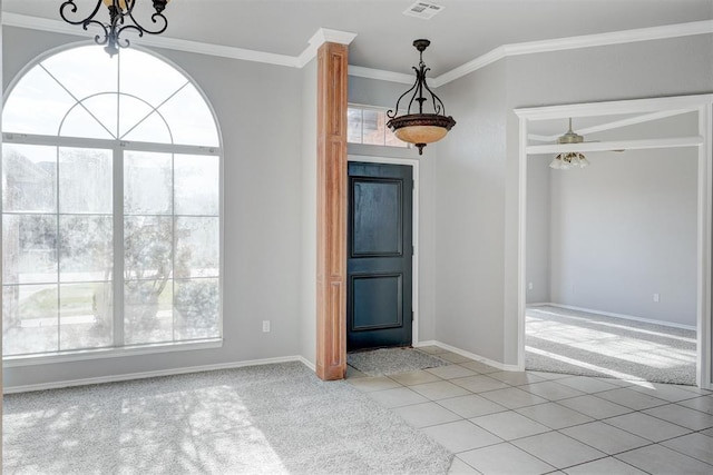 interior space with visible vents, a notable chandelier, ornamental molding, light tile patterned floors, and light colored carpet