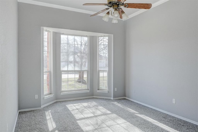 unfurnished room with carpet flooring, baseboards, a ceiling fan, and crown molding