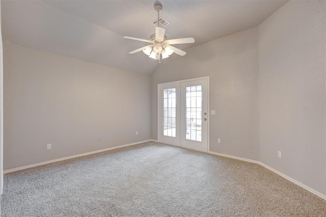 empty room featuring visible vents, baseboards, vaulted ceiling, carpet flooring, and a ceiling fan