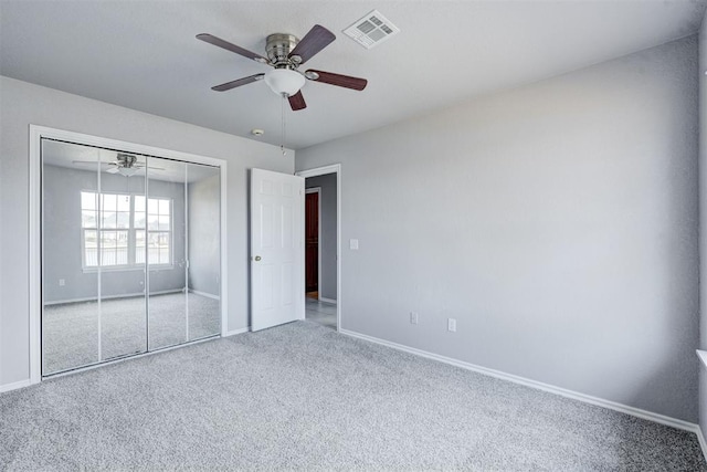 unfurnished bedroom with visible vents, baseboards, ceiling fan, carpet flooring, and a closet