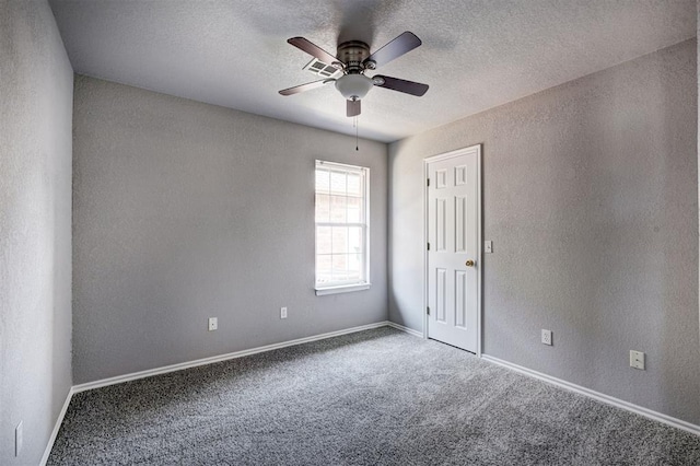 carpeted empty room with baseboards, a textured ceiling, ceiling fan, and a textured wall