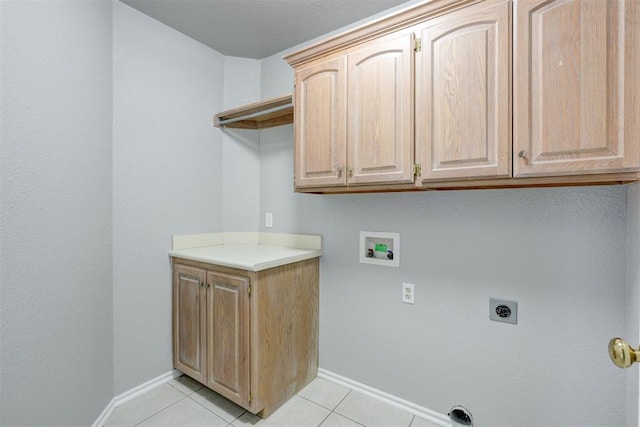 laundry room featuring baseboards, washer hookup, light tile patterned flooring, cabinet space, and electric dryer hookup