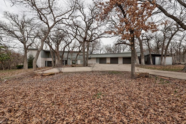 mid-century inspired home featuring concrete driveway