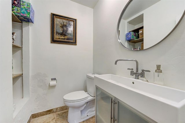 bathroom with toilet and vanity